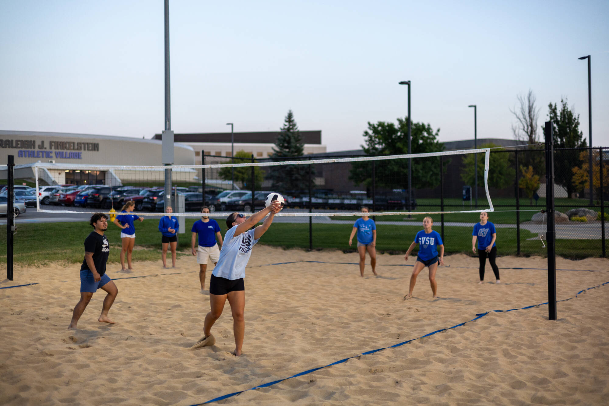 students playing sand volleyball